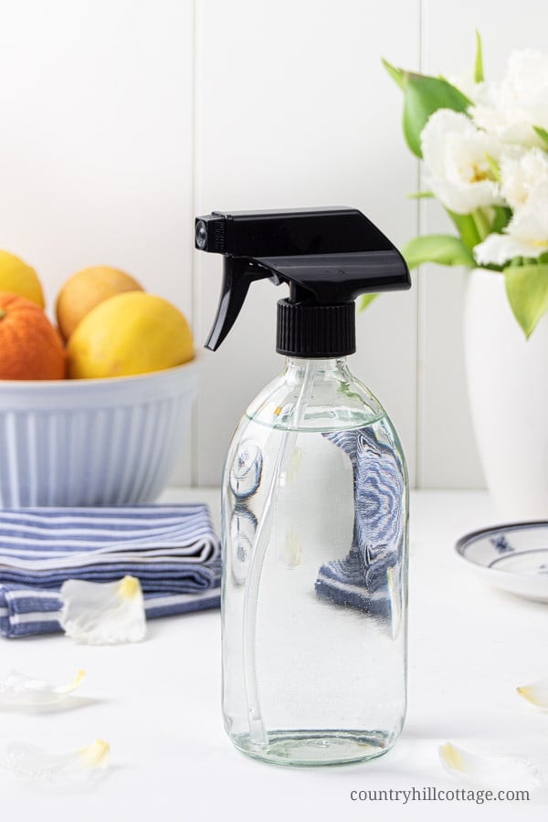 See how to make an easy DIY disinfectant spray with essential oils without harsh chemicals of other household cleaners. This vinegar-free homemade disinfectant spray recipe helps to fight harmful germs in you home. The natural DIY Lysol disinfecting spray is suitable for kitchen, bathroom, surfaces, furniture, bed, fabric, toys, safe for babies. Can be made with rubbing alcohol, vodka and peroxide. Includes free printable labels for packaging. #cleaning #essentialoils | countryhillcottage.com