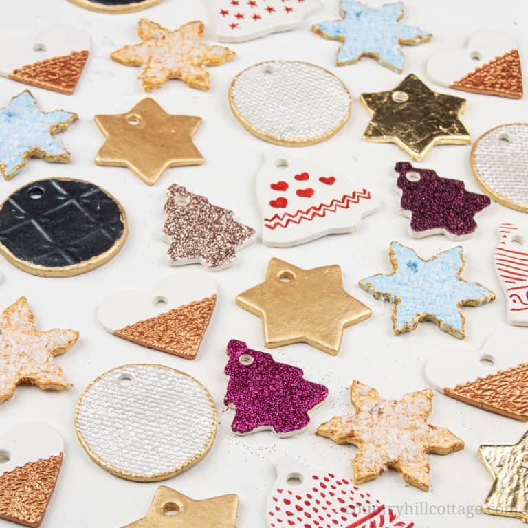 Festive air dry clay Christmas ornaments ideas! Homemade clay ornaments are beautiful and easy DIY cookie cutter ornaments and a simple winter craft. In this step-by-step tutorial with pictures, you’ll learn how to make ornaments like vintage painted snowflakes, rustic farmhouse jingle bells and beautiful glitter stars. You can use DIY Christmas ornaments as gifts and tree decorations. Great for kids and classroom! #christmasornaments #homemade #ornaments #holidays | countryhillcottage.com