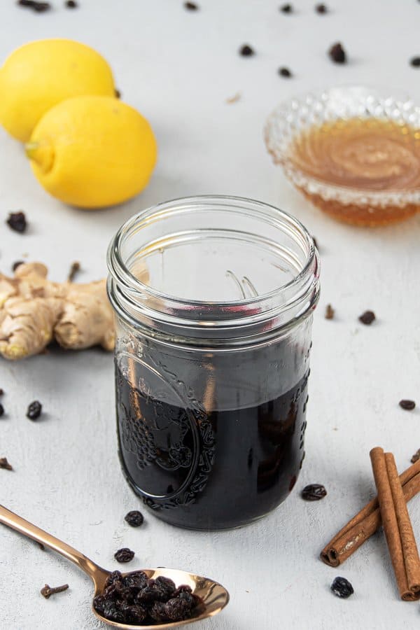 See how to make homemade thick elderberry syrup with dried elderberry. The DIY recipe can be made with turmeric, echinacea, rosehips, apple cider, essential oils, vegan without honey, in the Instant Pot, crockpot, pressure cooker or slow cooker. The syrup is great for colds, babies, kids and toddlers and has health benefits for the immune system. With tips for canning, uses, how to take, dosage chart and printable labels. #elderberries #elderberrysyrup #naturalremedy | countryhillcottage.com