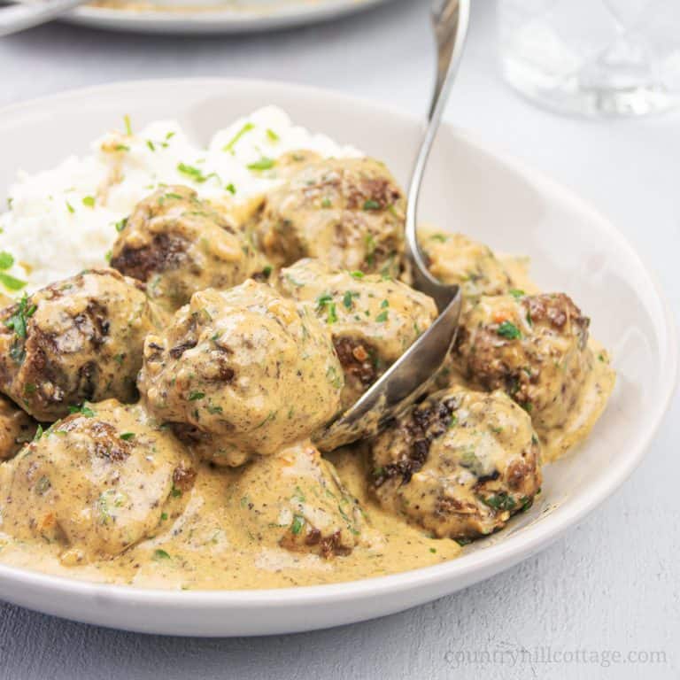 How to make healthy gluten-free Swedish meatballs from scratch! Light low carb stovetop meatballs in creamy gravy sauce are a quick easy family meal dinner, tastes authentic and traditional. The Ikea copycat homemade Keto meatball recipe is great for a crowd, as appetizer, and the freezer. Can me made with beef, pork, turkey or chicken. What to serve with: zucchini noodles, pasta, cauliflower mash or rice as side dishes. #meatballs #Swedishmeatballs #keto #glutenfree | countryhillcottage.com