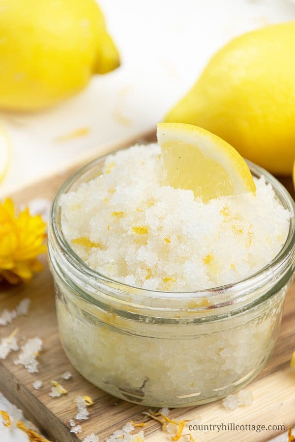 See how to make easy DIY lemon sugar scrub with essential oils and coconut oil! Homemade exfoliating lemon body scrub has many skincare benefits. You can create easy variations like, honey, raspberry or lavender. Simple organic lemon scrub also makes a great DIY gift idea. Comes with tips for how to use, packaging ideas, storage, shelf life and free printable labels. Great for shaving legs, foot, hands and lips. #sugarscrub #bodyscrub #lemonscrub #essentialoils #diygift | countryhillcottage.com