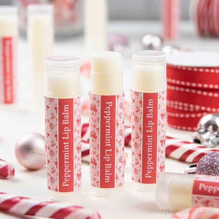 How to make the best peppermint lip balm! The easy natural DIY candy cane lip balm recipe is very moisturizing and perfect to soothe dry, cracked lips. The lip balm without beeswax is vegan and plant-based. The homemade peppermint chapstick is a cute Christmas gift and comes with free printable lip balm labels for packaging tube and containers. Made with shea butter and essential oils, great for kids. #lipbalm #peppermint #candycane #printable #essentialoils #holidays | countryhillcottage.com