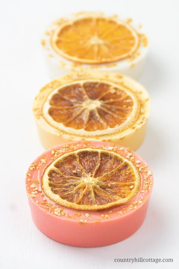 This homemade citrus soap recipe has an uplifting scent, rich lather and many skin care benefits. Natural DIY lemon soap bars are made with goat milk, shea butter or glycerin melt and pour base and essential oils - ideal for soap making for beginners! The handmade tutorial shows how to make melt and pour soap, gives different citrus essential oil blends for soap, tips for molds, packaging ideas and more recipes inspiration. Cute hand soap teacher gift! #soap #soapmaking | countryhillcottage.com