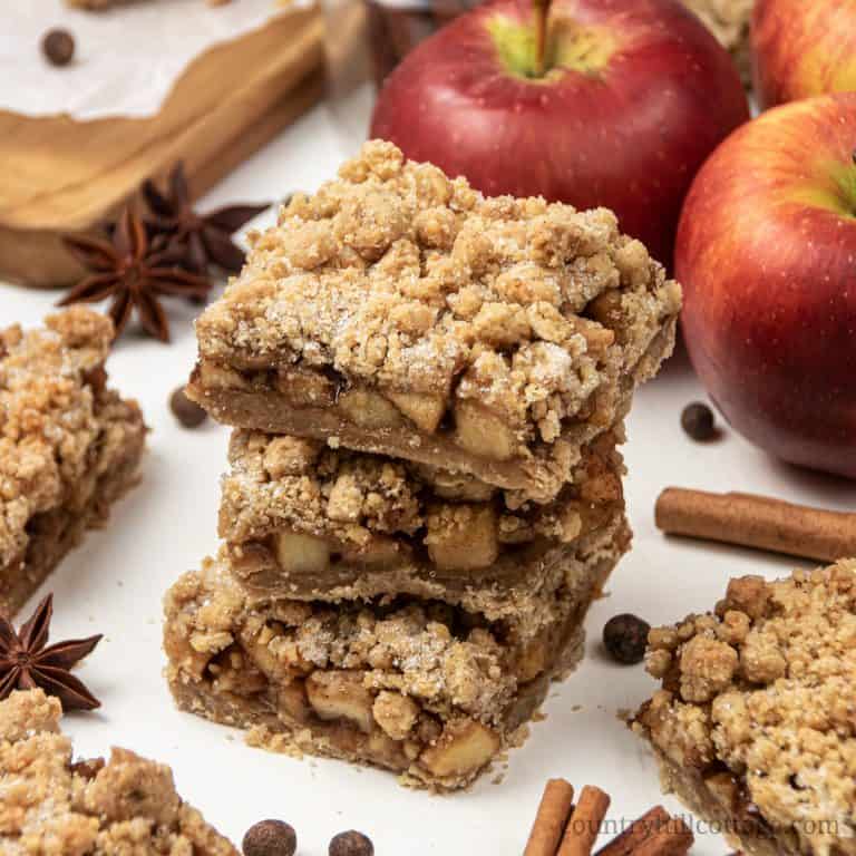 Vegan apple crisp bars with streusel topping are a healthy gluten-free apple recipe for fall! See how to make easy apple pie crisp bars with just 20 minutes prep. The apple pie bars recipe is super easy and quick, the filling has a lovely caramel note similar to canned pie fillings! Try apple crumble bars for breakfast, afternoon snack, tea time, or dessert. You’ll just love apple streusel bars, great for a crowd. #applepie #applepiebars #applecrispbars #applecrumbsbars | countryhillcottage.com