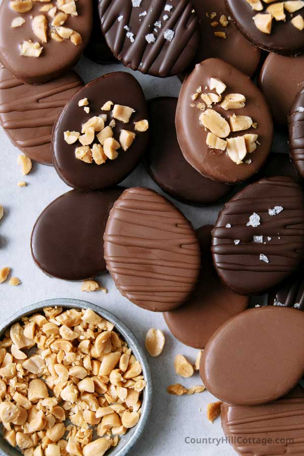 stack of chocolate covered peanut butter eggs on wax paper.